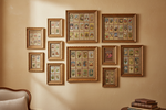 Framed tea card collections hanging on an almond wall