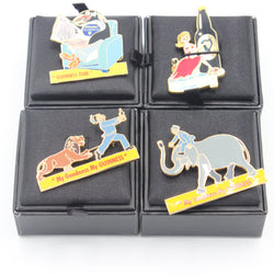 Four enamel pin badges featuring Guinness-themed characters and logos, displayed on a black velvet grid with black presentation boxes.