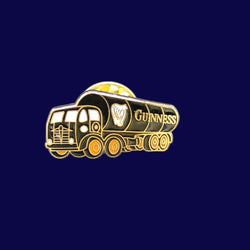 Gold-colored Guiness tanker truck-shaped pin badge on a blue textured background