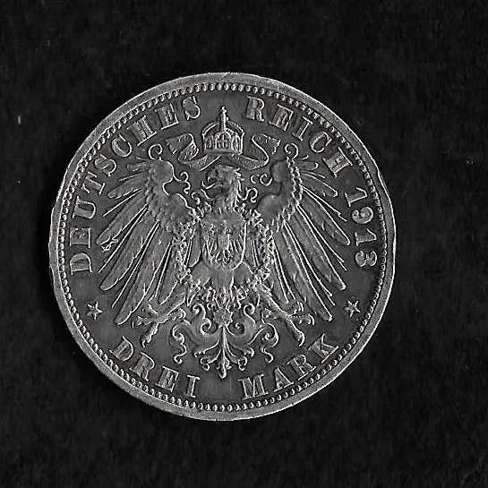 A 1913 German Reich 3 Mark silver coin featuring the imperial eagle emblem, shown against a dark textured background.