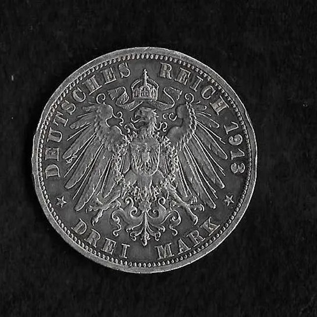 A 1913 German Reich 3 Mark silver coin featuring the imperial eagle emblem, shown against a dark textured background.