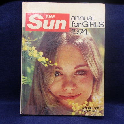 Cover of 'The Sun' annual for girls 1974 with a girl's face and flowers on a blue background