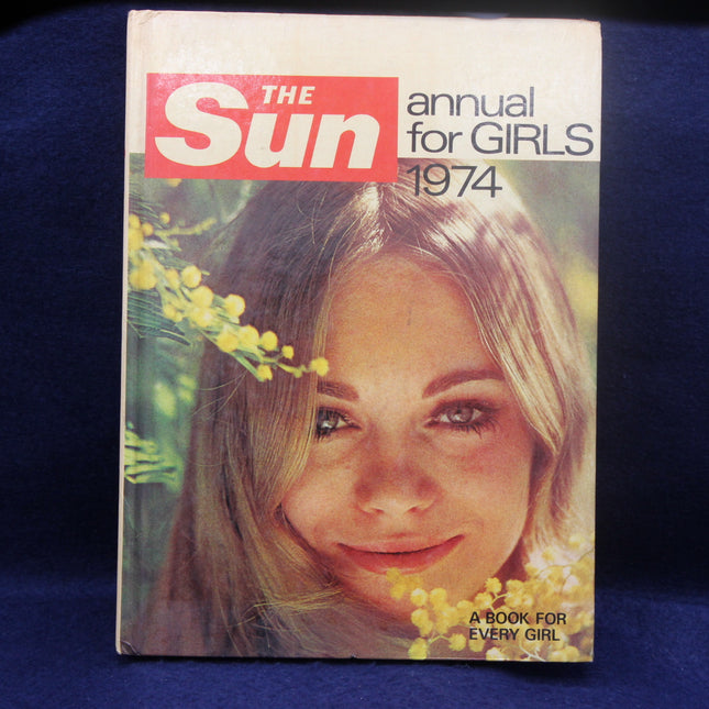 Cover of 'The Sun' annual for girls 1974 with a girl's face and flowers on a blue background