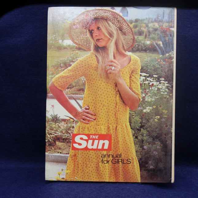 Vintage 'The Sun' annual for girls with a woman in a yellow dress and hat on the cover.