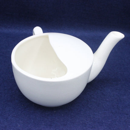 White ceramic jugt on a blue background