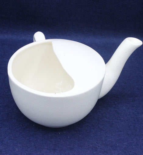 White ceramic jugt on a blue background