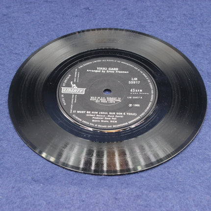 Vinyl record with label on a blue surface