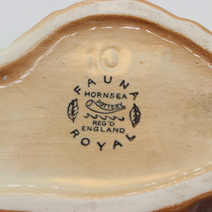 Close-up of the inside bottom of a ceramic plate or dish, showing the printed mark 'FAUNA HORSESEA POTTERY REG'D ENGLAND' and the embossed number '10' on a glossy beige glaze.