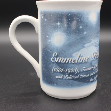 White mug with a blue celestial design and text on a dark background