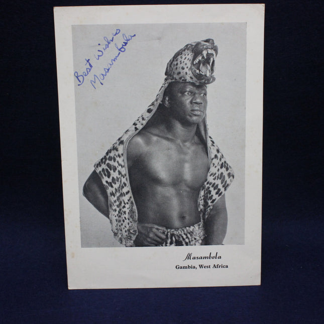 Vintage photograph of a man wearing a leopard skin headpiece with text on a dark background