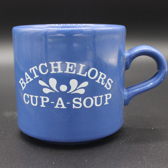 Blue mug with 'BACHELORS CUP-A-SOUP' text on a dark background
