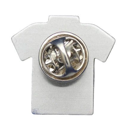 White shirt-shaped pin with a circular design on a blue background