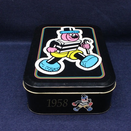 Black tin box with cartoon character on a blue background