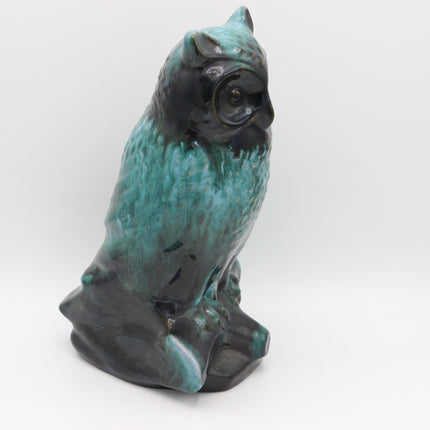 A ceramic owl figurine with a textured turquoise and black glazed finish, photographed against a seamless white studio background.