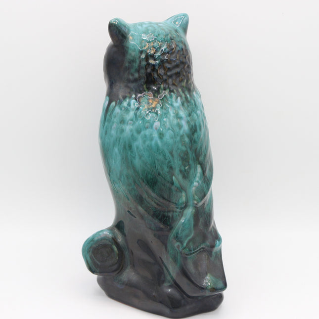 A ceramic owl figurine with a glossy turquoise and black glaze, shown from the back against a plain white background.