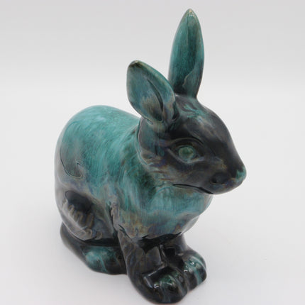 A ceramic rabbit figurine with a glossy teal and black glaze, shown against a plain white background.