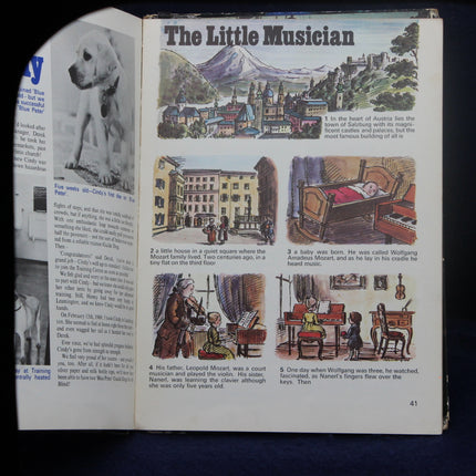 Open book with illustrations and text titled 'The Little Musician' on a dark background
