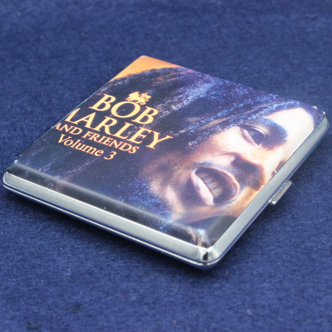 Cigarette case with 'Bob Larley and Friends Volume 3' text on a blue background