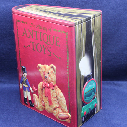 Book titled 'The History of Antique Toys' with a teddy bear illustration on a blue background