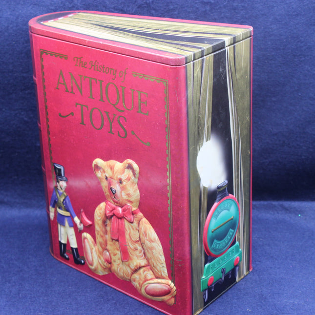 Book titled 'The History of Antique Toys' with a teddy bear illustration on a blue background
