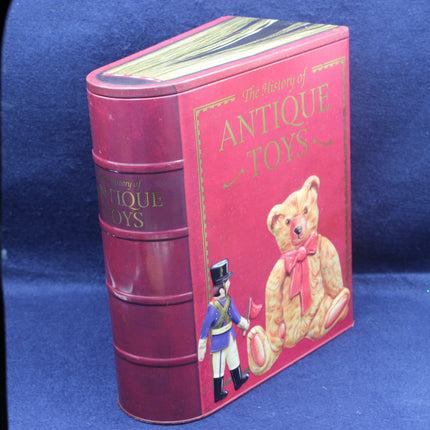 Red cylindrical box with a teddy bear and toy soldier illustration on a blue background