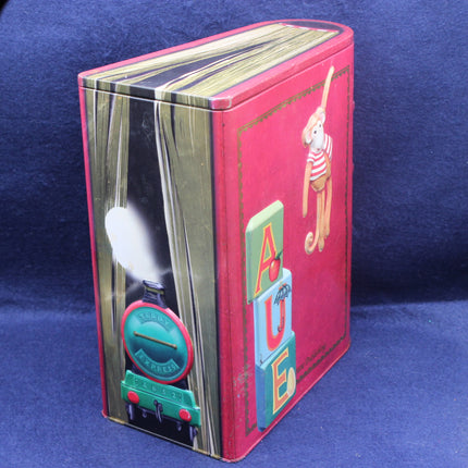 Red book-shaped tin with a train design on a blue background
