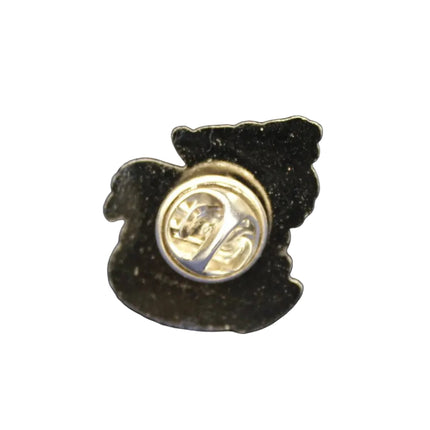 Small black and gold pin on a blue textured background