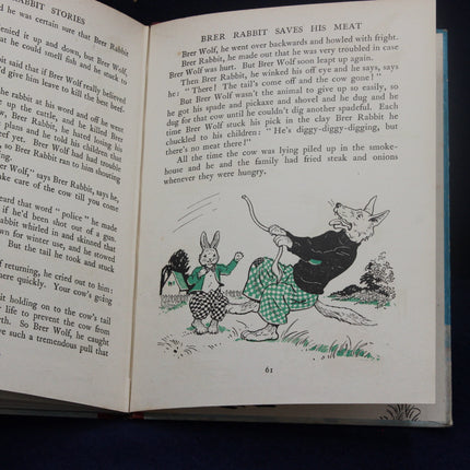 Open book with illustrated story of Brer Rabbit and Brer Wolf