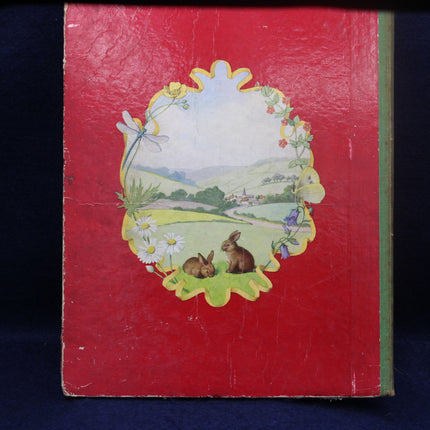 Vintage book cover with decorative illustration of bunnies, flowers, and a landscape on a red background.