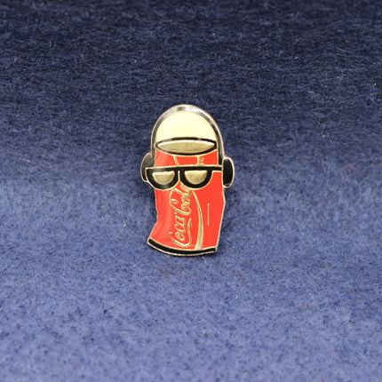 Pin with Coca-Cola bottle design on a blue background
