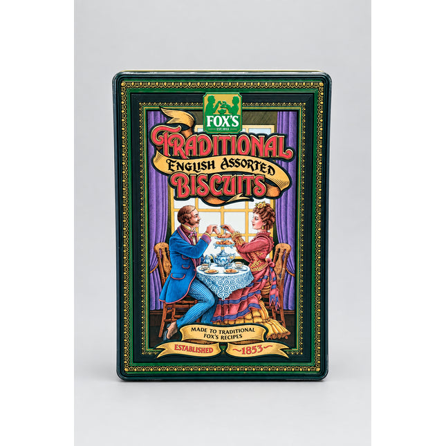 A vintage tin of Fox's Traditional English Assorted Biscuits standing upright on a bright green textured background. The tin features an illustrated Victorian scene with a man and woman at a table, and the brand name 'Fox's' is visible at the top.