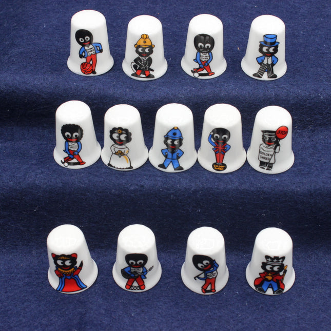 Set of white thimbles with Golly characters on a blue background