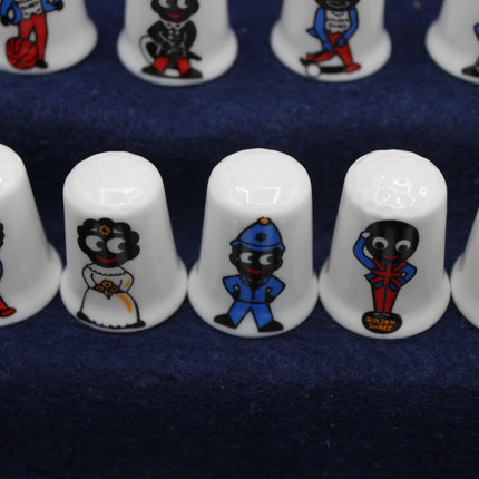 White thimbles with Golly figures on a blue background