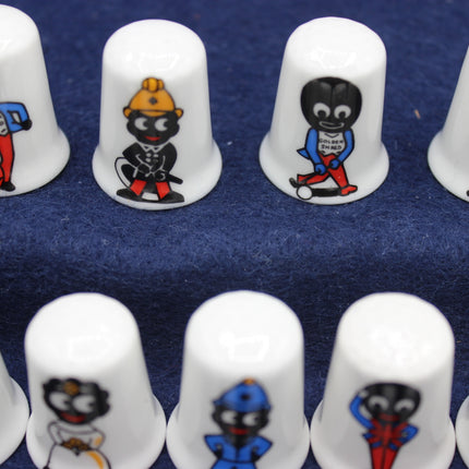 White thimbles with Golly figures in various poses on a blue background