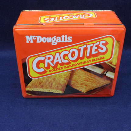 Orange tin box of McDougall's Cracottes crackers on a blue background