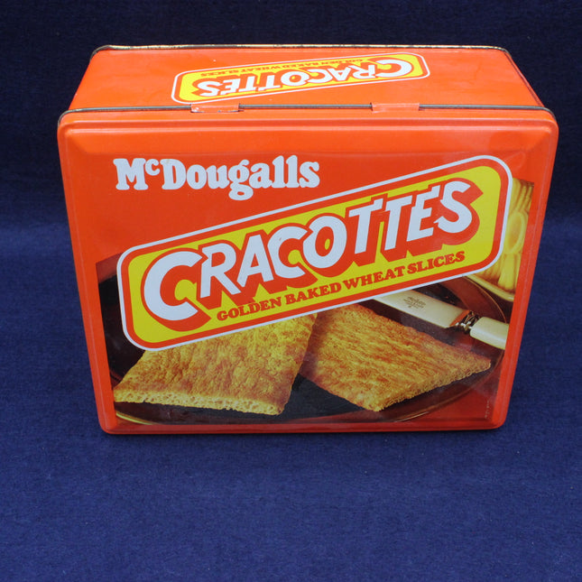 Orange tin box of McDougall's Cracottes crackers on a blue background