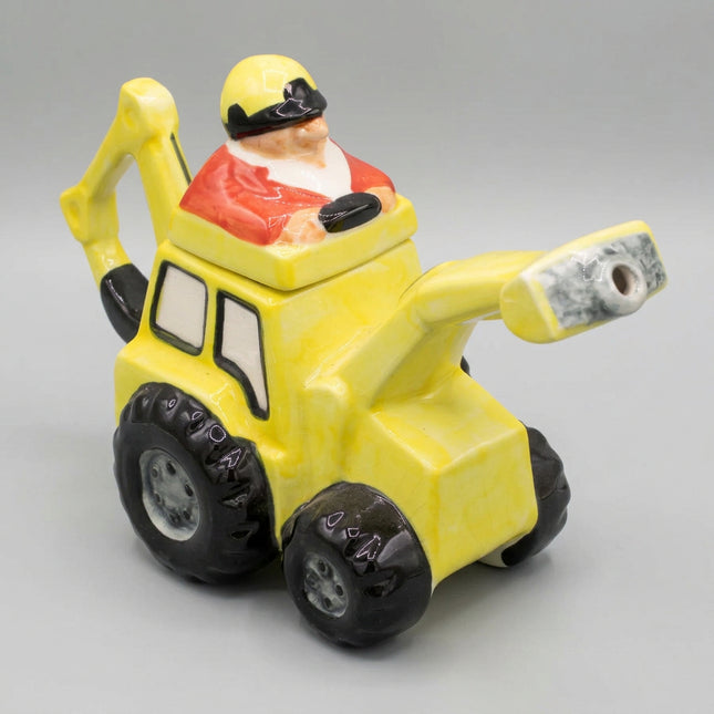 Yellow toy bulldozer with a Santa Claus figure on a dark blue background