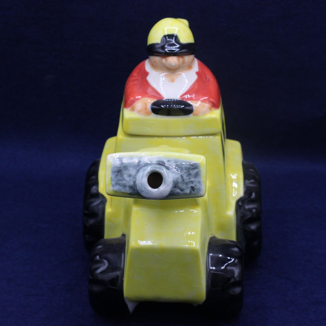 Toy figure of a character on a yellow vehicle with a dark blue background