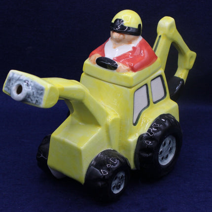 Toy figure of a character in a yellow vehicle on a dark blue background