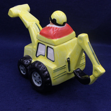 Yellow toy excavator with a red scoop on a blue background