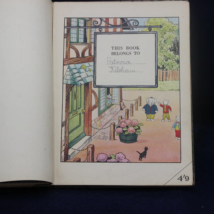 Illustrated book cover with children and a dog, featuring 'This Book Belongs To' text.