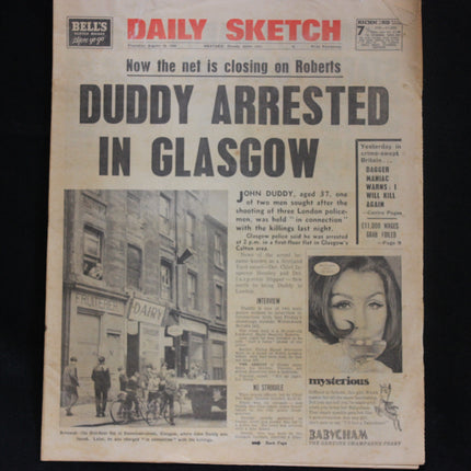 Vintage newspaper with headline 'Duddy Arrested in Glasgow' on a black background