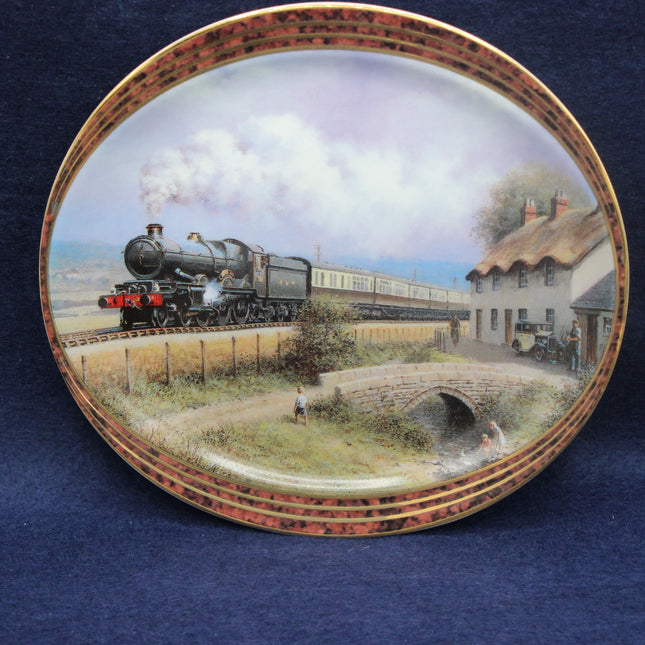 Decorative plate with a steam train scene on a blue background
