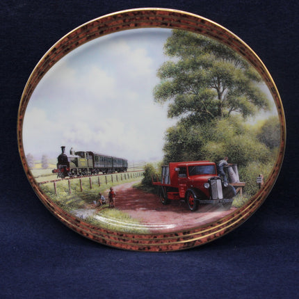 Decorative plate with a scenic design of a red truck and steam train on a blue background