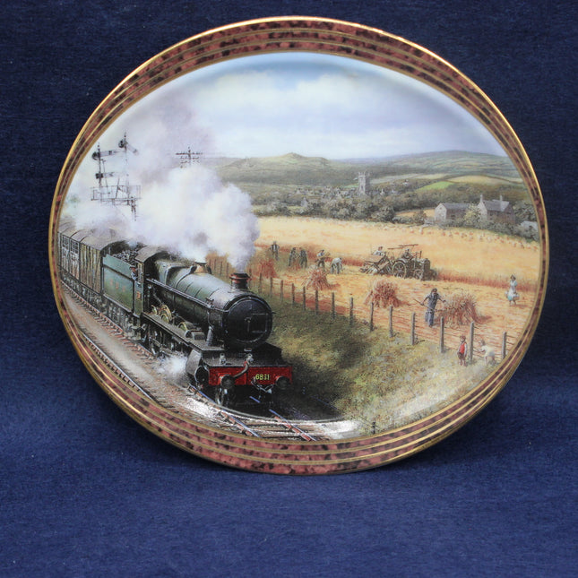 Decorative plate with a steam train scene on a blue background