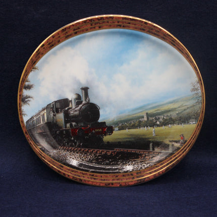 Decorative plate with a steam train design on a dark background
