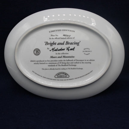 White plate with engraved text on a dark background