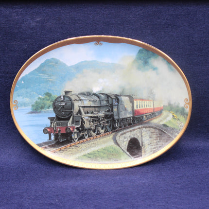 Decorative plate with a steam train design on a blue background