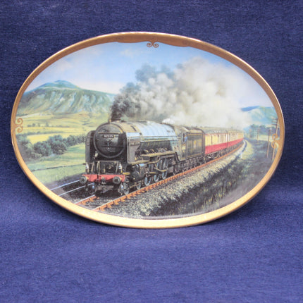 Decorative plate with a steam train design on a blue background