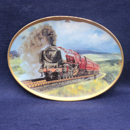 Decorative plate with a red steam train on a blue background